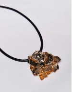 Curve necklace with large hammered floral pendant in gold tone